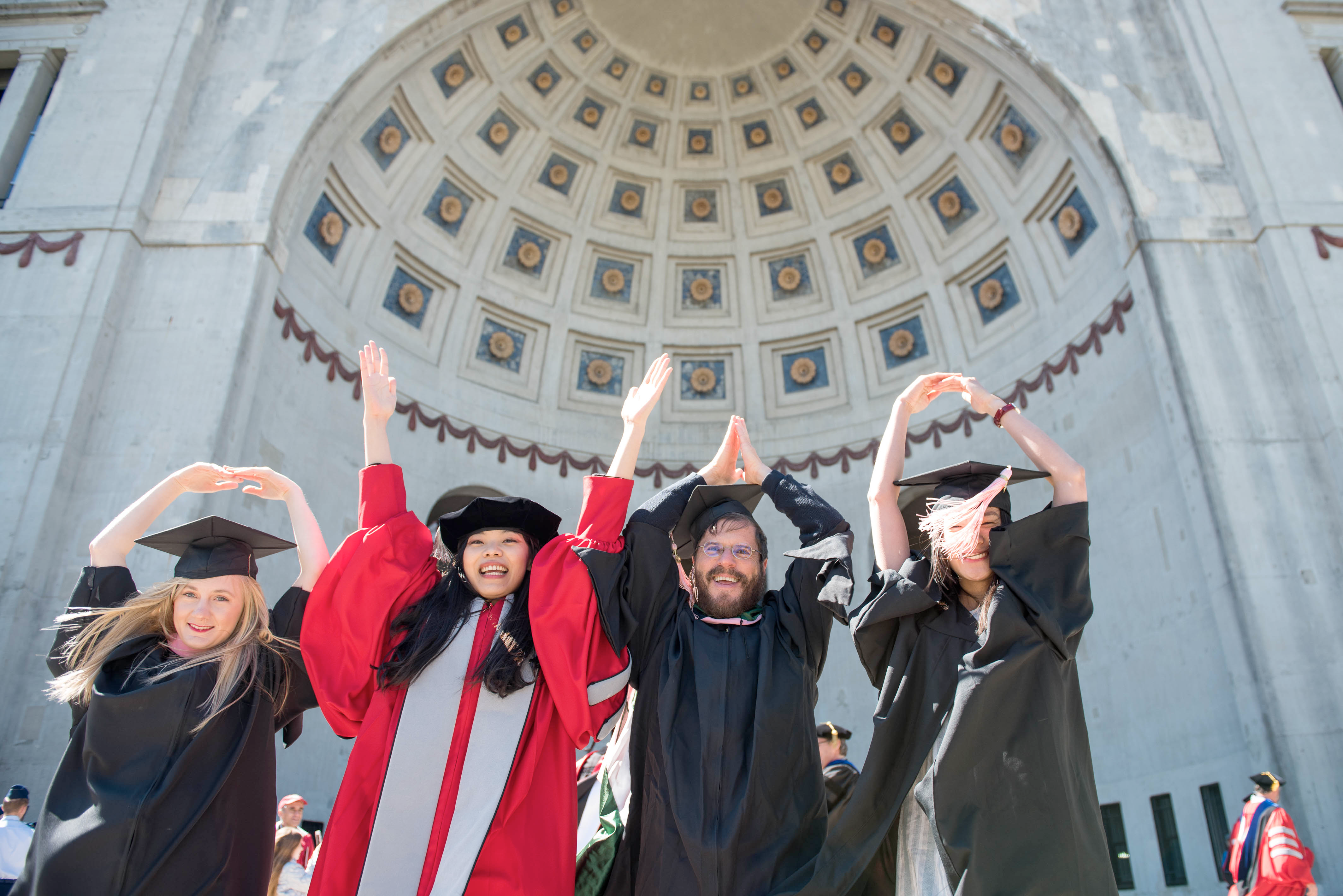 graduates in front of stadium