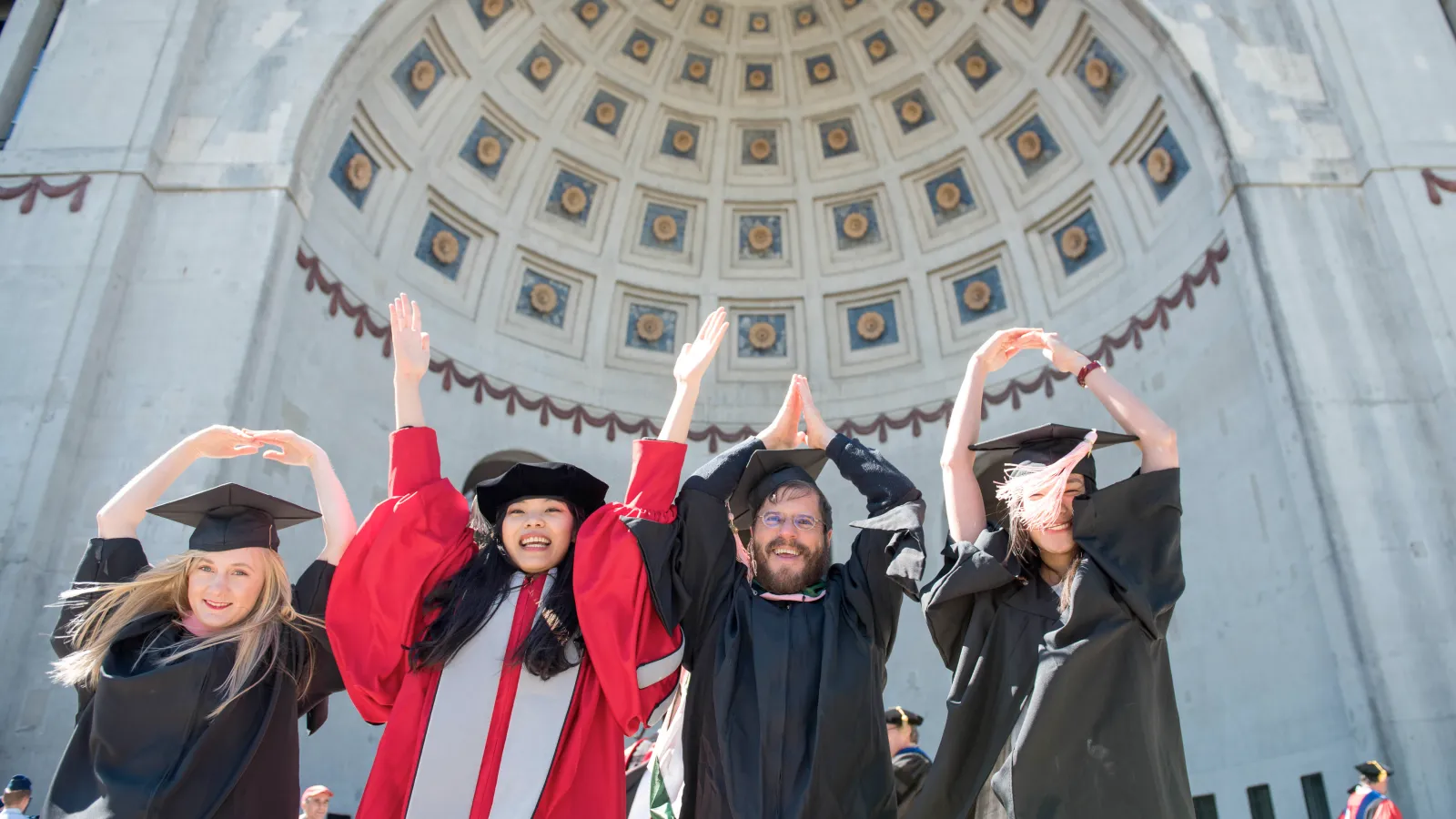 graduates in front of stadium