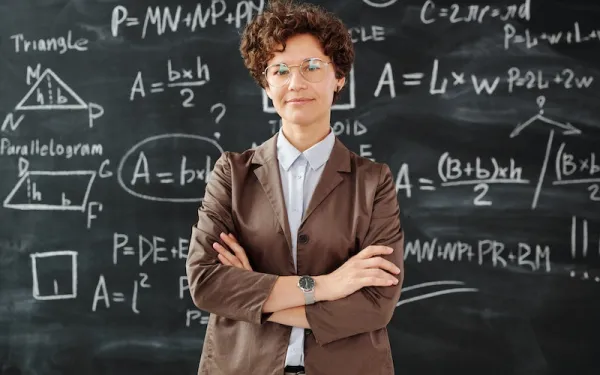 teacher in front of math board