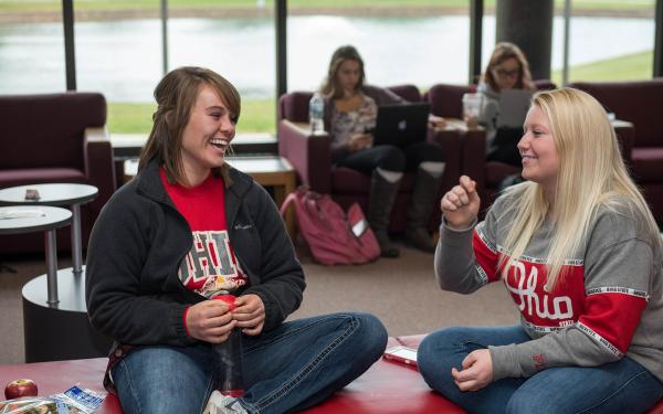 Two students converse at Thompson library