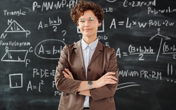 teacher in front of math board