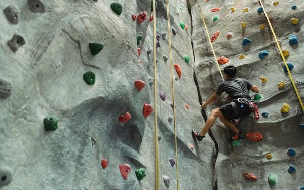 Man climbing on a wall in a rock climbing gym