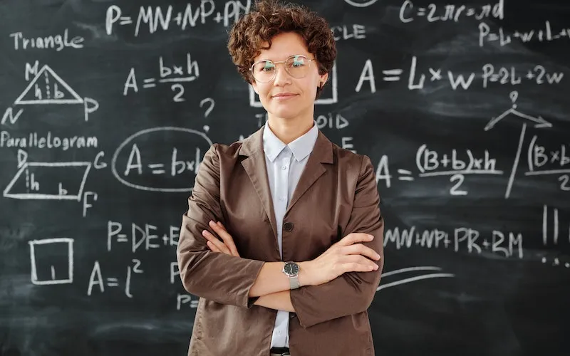 teacher in front of math board