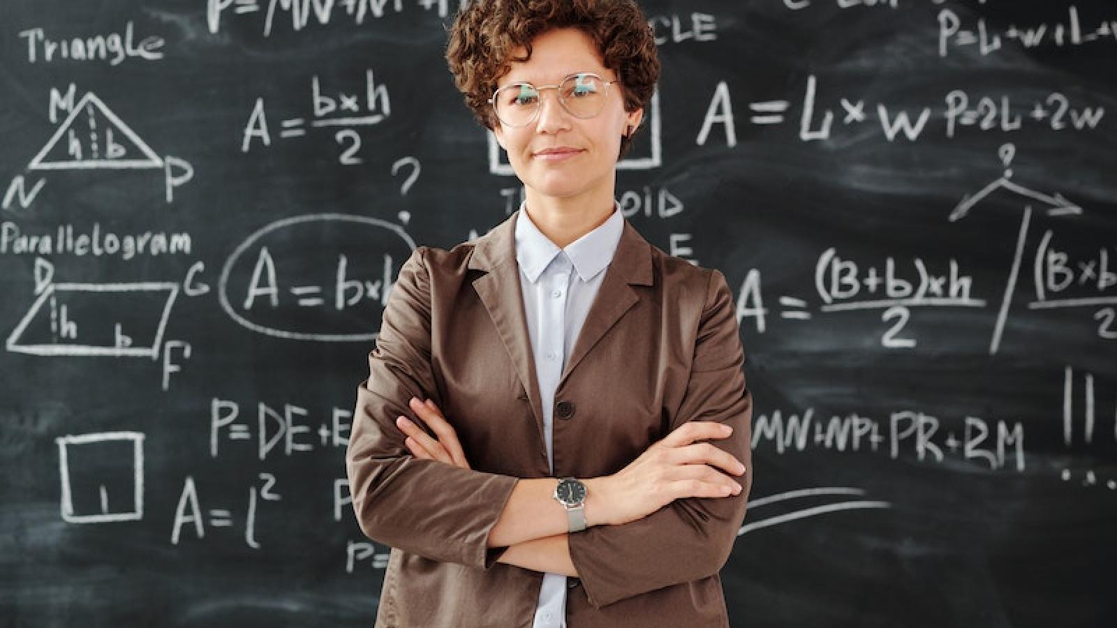 teacher in front of math board